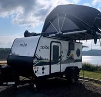 "The Eagle's Nest" 2023 NoBo 10.7 with rear kitchen, fireplace, TV, Rhino Rack, and optional King-sized rooftop tent