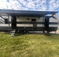 Clean camper with unique layout, outdoor kitchen, and Verlo mattress