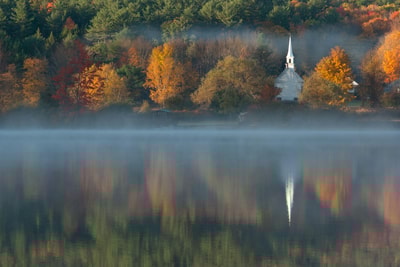 White chapel by water in New Hampshire