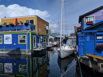 Boat docked near colorful houses Victoria BC