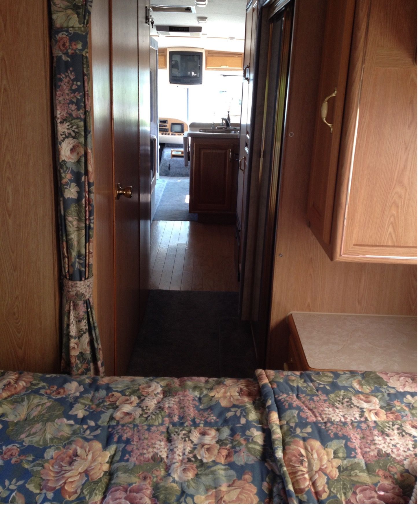 A view inside a used motorhome looking toward the front from the bedroom 