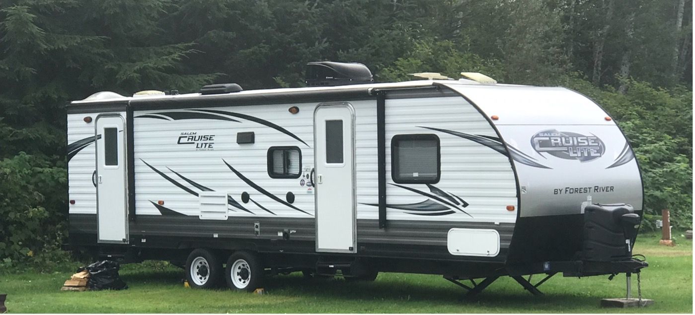 a black and white Cruise Lite travel trailer