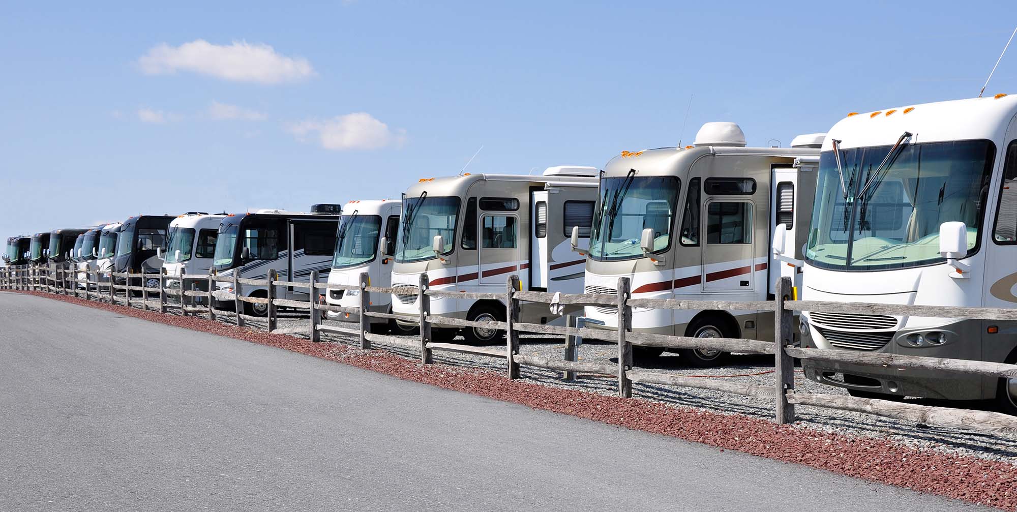 long row of class a motorhomes for sale